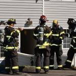 Poulsbo firefighters get ready to go into an apartment where a possible fire was reported, Sept. 26 at Liberty Ridge in Poulsbo. (Mark Krulish/Kitsap News Group)