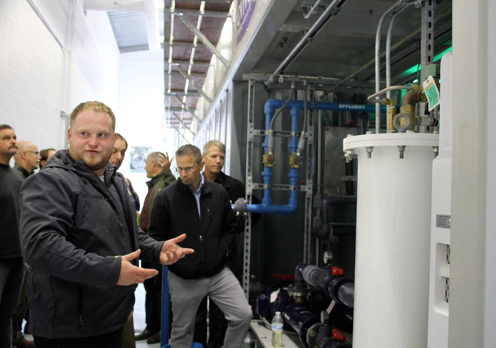 Luke Thurston, KPUD employee, explains the mechanics of the treatment system at the Port Gamble Resource Recovery Facility.                                Michelle Beahm / Kitsap News Group