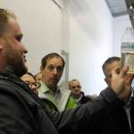 Luke Thurston, KPUD staff member, shows a crowd of people what the water looks like after being treated at the Port Gamble Resource Recovery Facility.                                Michelle Beahm / Kitsap News Group