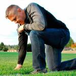 Joe Kennedy kneels on the 50-yard line of a football field in prayer in a photograph provided the Liberty Institute. Kennedy and his lawyers filed a petition Sept. 21 requesting that his case be considered by the entire circuit court &mdash; 11 judges, including the chief judge.