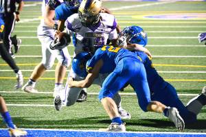 North Kitsap running back Dax Solis bulls his way through a group of defenders on his way to a touchdown. (Mark Krulish/Kitsap News Group)