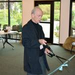 Eric Petersen, Bainbridge Public Library Board President, cuts the ribbon on the newly-remodeled library on Oct. 14. (Mark Krulish/Kitsap News Group)