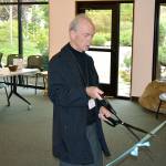 Eric Petersen, Bainbridge Public Library Board President, cuts the ribbon on the newly-remodeled library on Oct. 14. (Mark Krulish/Kitsap News Group)