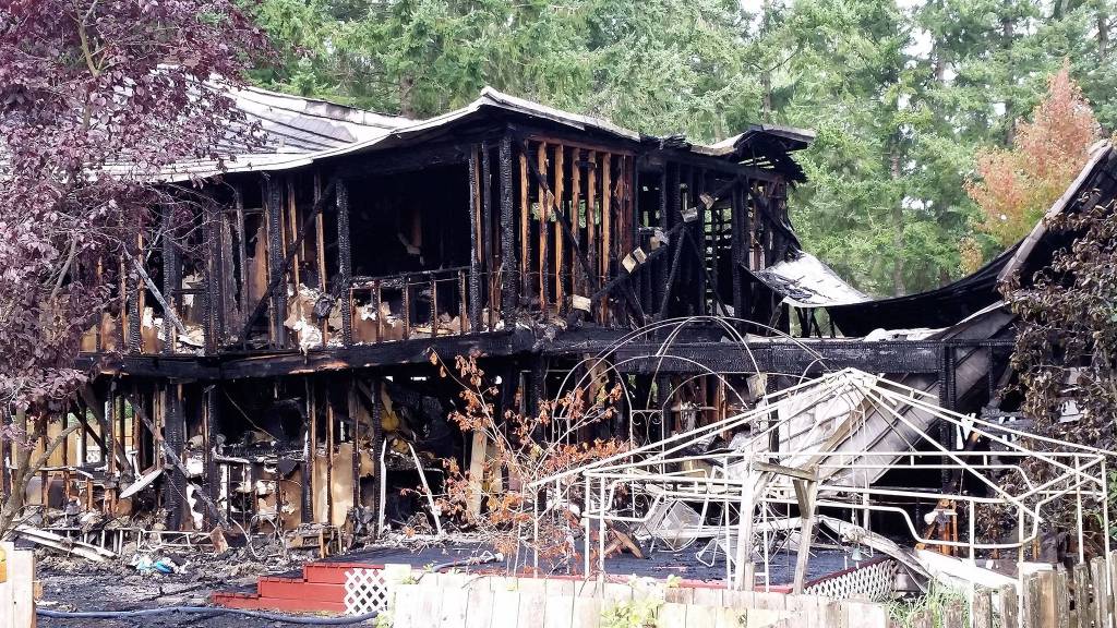 A two-story, two-alarm Saturday morning fire destroyed a South Kitsap home and killed four members of the Simpson family inside. Grandfather, father and husband Don Simpson was found by firefighters from South Kitsap Fire and Rescue and assisting crews from Central Kitsap Fire and Rescue and Bremerton Fire shortly after he had escaped the burning home. Photo: Courtesy of Doug Rinehart