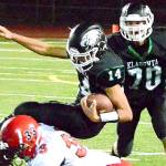 Klahowya quarterback John Hartford (14) is tackled by Jacob Boucher (33) of Port Townsend during the Eagles&rsquo; 7-6 victory on Oct. 14. (Mark Krulish/Kitsap News Group)