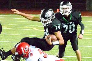 Klahowya quarterback John Hartford (14) is tackled by Jacob Boucher (33) of Port Townsend during the Eagles&rsquo; 7-6 victory on Oct. 14. (Mark Krulish/Kitsap News Group)