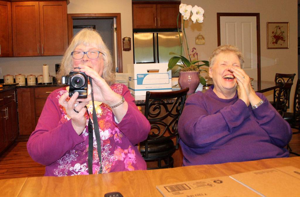 P.E.O. chapter president Fran Valley takes a photograph of a reporter taking her picture, drawing a laugh from Darlene Olmsted. (Richard Walker/Kitsap News Group)
