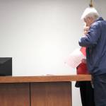 Kerry Stevens and Larry Mann receive a copy of the temporary protection orders, keeping Mann away from Karst Brandsma and Magnalyna Geisler until a final decision is announced Nov. 1.                                (Photo: Michelle Beahm | Kitsap Daily News)