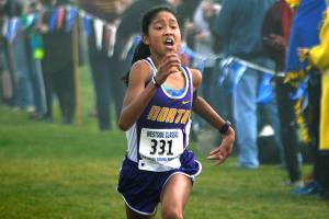 North Kitsap freshman Madison Zosa sprints to the finish line at the West Central District meet on Oct. 28 at Chambers Bay. She won the race with her time of 19:19.70. Mark Krulish/Kitsap News Group
