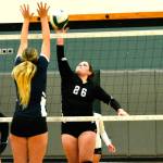 Klahowya&rsquo;s Chloe Settle looks to tip a ball past the Cascade Christian blockers during their district match on Nov. 2. (Mark Krulish/Kitsap News Group)