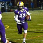 North Kitsap running back Dax Solis (32) runs past the blocks of his teammates during the Vikings&rsquo; district playoff win over Eatonville.