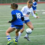 Olympic&rsquo;s Saoirse Brown tries to dribble past her numeral counterpart during a district game against Fife. The Trojans won 4-0. (Mark Krulish/Kitsap News Group)