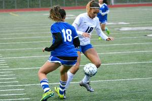 Olympic&rsquo;s Saoirse Brown tries to dribble past her numeral counterpart during a district game against Fife. The Trojans won 4-0. (Mark Krulish/Kitsap News Group)