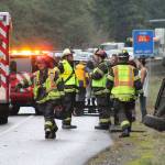 Emergency responders at the scene of an overturned vehicle along SR 305 in Poulsbo, near Bond Road.