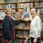 From left, volunteers Bonnie Chrey and Katherine Smith pose near the selection of magazines at the Tracyton Library. (Leslie Kelly/Kitsap News Group)