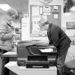 Bonnie Chrey helps a library patron check out a book from the Tracyton Library. Anyone can use the independent library.                                Leslie Kelly | Kitsap Daily News
