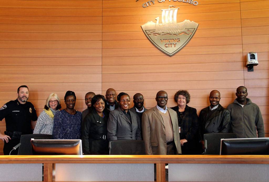 Mayor Becky Erickson and Ugandan officials stop for photos in the City Council chambers at Poulsbo City Hall, Nov. 10. Ugandan officials visited City Hall as part of a regional tour to develop political and trade relationships. (Richard Walker/Kitsap News Group)