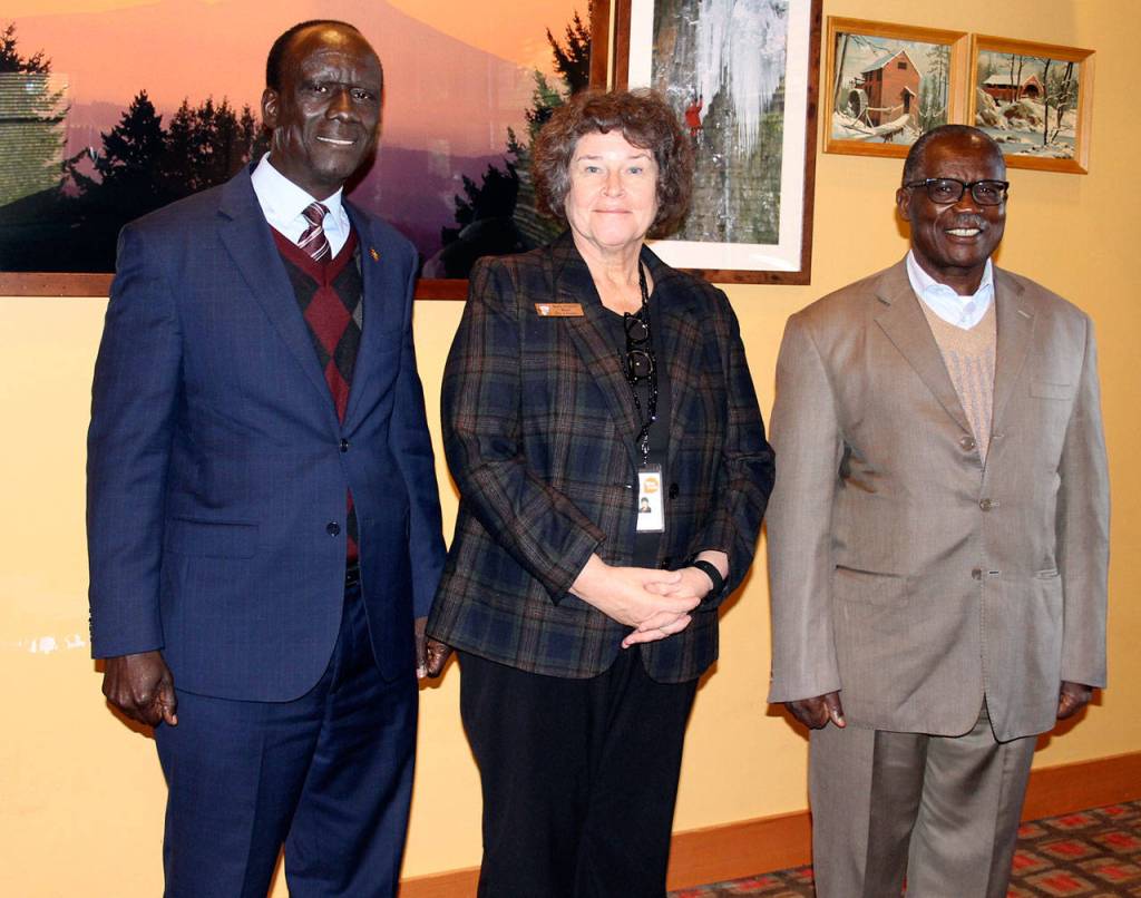 From left, Ugandan Ambassador to the United States Mull S. Katende, Mayor Becky Erickson and Uganda security minister Wilson Mukasa meet during lunch Nov. 10 in the Elmers restaurant banquet room. Ugandan officials visited Poulsbo as part of a regional tour to develop political and trade relationships. (Richard Walker/Kitsap News Group)