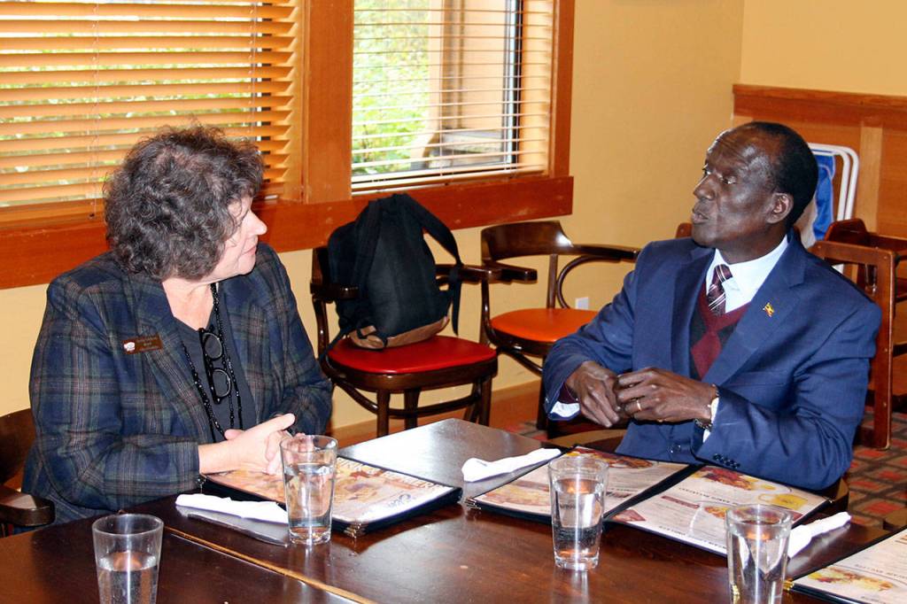 Mayor Becky Erickson and Ugandan Ambassador to the United States Mull S. Katende chat during lunch Nov. 10 in the Elmers restaurant banquet room. Katende and other Ugandan officials visited Poulsbo as part of a regional tour to develop political and trade relationships. (Richard Walker/Kitsap News Group)