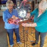 Volunteers stirng lights for the annual festivities.