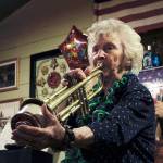 Yvonne McAllister plays her trumpet during her 96th birthday celebration at Casa Mexico in Keyport. Nick Twietmeyer | Kitsap News Group.