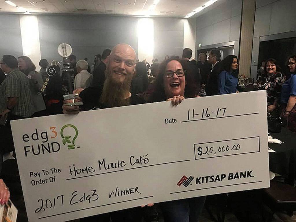 Home Made Cafe partners Paul Robinson and Suanne Martin Smith display a ceremonial check for $20,000 as winners of Kitsap Banks edg3 Fund award for small business entrepreneurs. They won the award at a dinner and presentation competition at the Kitsap Conference Center at Harborside in Bremerton. (Photo: Courtesy Home Made Cafe)