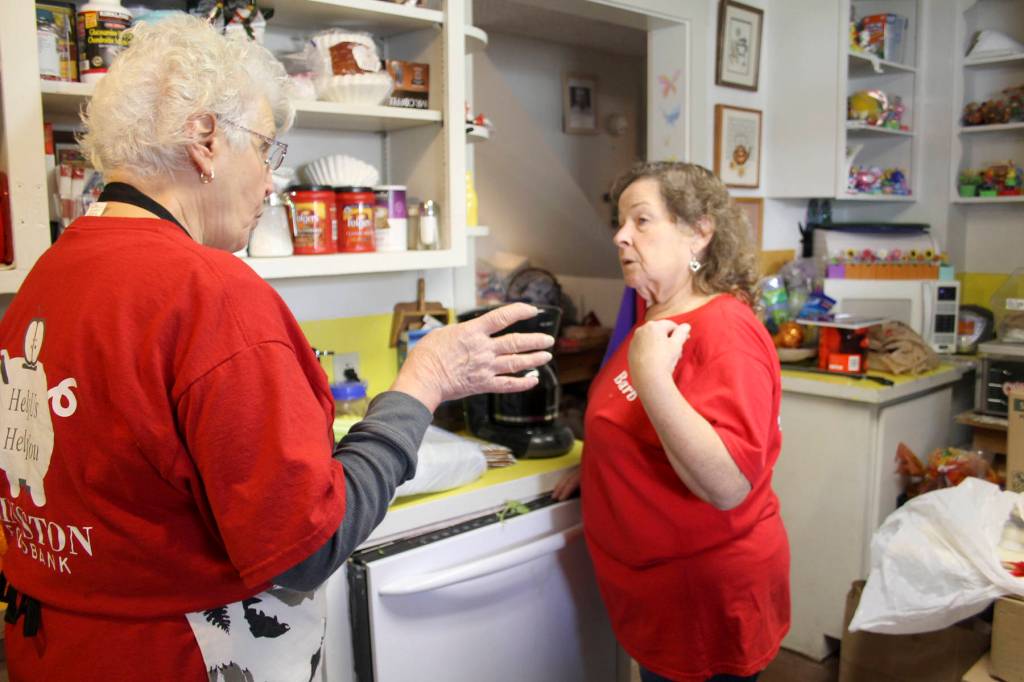 From left, Barb Brooklyn Piperata and Barb Fulton discuss storage of donated food items at the Kingston Food Bank, Nov. 17. (Richard Walker/Kitsap News Group)