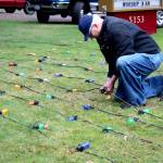 Bob Carter repaired the 600 lights that decorate the Tracyton Community Tree.                                Michelle Beahm / Kitsap News Group