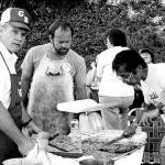Longtime Friends of Manchester Library volunteer Nobi Kawasaki (slicing salmon) helped out at a salmon bake fundraiser in the 1970s. (Photo: Manchester Library photo)