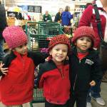 Alan, Alexa and Augustine all got to pick out new hats last week at Fishline, hand-knitted by volunteers.                                North Kitsap Fishline/Courtesy photo