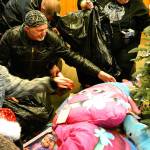 Larry Litsch, a volunteer for the North Kitsap ABATE Toy Run, unpacks a bag full of gifts. (Mark Krulish/Kitsap News Group)
