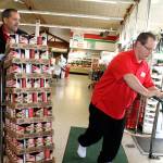 From left, Poulsbo Red Apple Market owner Jeff Uberuaga helps load donated canned goods into Les Schwab Tire Center trucks for delivery to Food Lifeline, Nov. 17. (Richard Walker/Kitsap News Group)