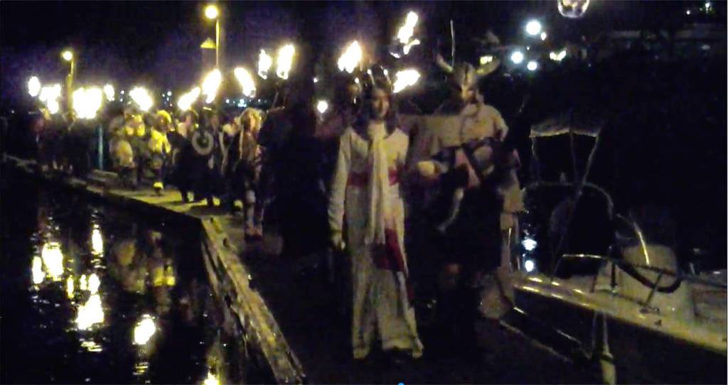 Vikings escort the Lucia Bride from Poulsbo Marina to Muriel Iverson Williams Waterfront Park, Dec. 2 during Julefest. (Richard Walker/Kitsap News Group)