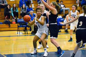 <em>Olympic senior Kiki Mitchell looks to go up for a basket against Bainbridges Anna Kozlosky and Grace Carson (right). Bainbridge won the game 56-43. </em>Mark Krulish/Kitsap News Group