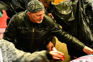 <em>Larry Litsch, a volunteer for the North Kitsap ABATE Toy Run, unpacks a bag full of gifts. </em>Mark Krulish/Kitsap News Group