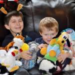 From left, Zachary Darner and Noah Darner sit among some of the early toys collected for Kidzz Helping Kidzz 2017. As of Dec. 5, Zachary collected more than 500 toys, and hopes to collect 500 more before time is up Dec. 18.                                Michelle Beahm / Kitsap News Group