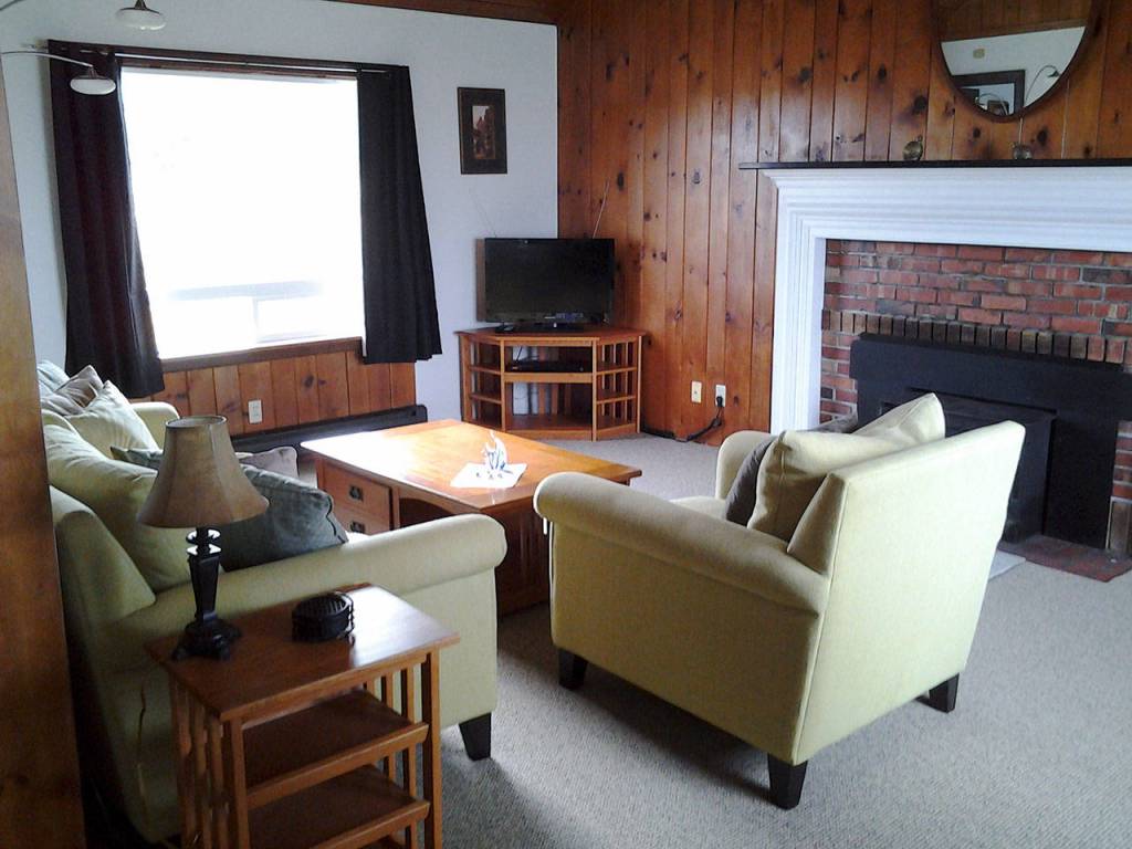 The home is tastefully appointed in furnishings from the 1940s and earlier; a coffee table features Mission-style design and inlays. The bathroom is tiled, and the adjacent bedroom is light and white and airy. (Richard Walker/Kitsap News Group)                                 The home is tastefully appointed in furnishings from the 1940s and earlier; a coffee table features Mission-style design and inlays. The bathroom is tiled, and the adjacent bedroom is light and white and airy. (Richard Walker/Kitsap News Group)