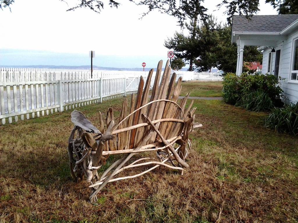 The grounds of the Maggs House and adjacent light station feature driftwood art works by Travis Foreman. This bench on the lawn entices visitors to sit and enjoy the sea view. (Richard Walker/Kitsap News Group)                                 The grounds of the Maggs House and adjacent light station feature driftwood art works by Travis Foreman. This bench on the lawn entices visitors to sit and enjoy the sea view. (Richard Walker/Kitsap News Group)