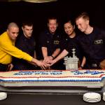 U.S. Navy sailors aboard the aircraft carrier USS Nimitz (CVN 68), cut the Sailor of the Year cake, Nov. 3 in the Sea of Japan. From left, Aviation Boatswains Mate (Handling) 1st Class Hugo Echeverritrujillo, Senior Sailor of the Year; Hospital Corpsman 2nd Class James Gibbens, Sailor of the Year; Capt. Kevin Lenox, commanding officer; Electronics Technician 3rd Class Dallymae Arce, Junior Sailor of the Year; Air Traffic Controller Airman Apprentice Connor Jonas, Blue Jacket of the Year. (Mass Communication Specialist Seaman Emily Johnston/U.S. Navy)