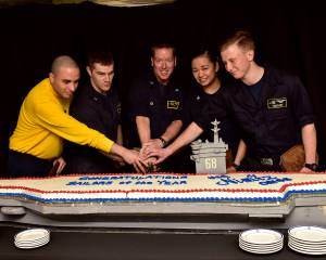 U.S. Navy sailors aboard the aircraft carrier USS Nimitz (CVN 68), cut the Sailor of the Year cake, Nov. 3 in the Sea of Japan. From left, Aviation Boatswains Mate (Handling) 1st Class Hugo Echeverritrujillo, Senior Sailor of the Year; Hospital Corpsman 2nd Class James Gibbens, Sailor of the Year; Capt. Kevin Lenox, commanding officer; Electronics Technician 3rd Class Dallymae Arce, Junior Sailor of the Year; Air Traffic Controller Airman Apprentice Connor Jonas, Blue Jacket of the Year. (Mass Communication Specialist Seaman Emily Johnston/U.S. Navy)