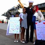 U.S. Navy Aviation Maintenance Administrationman 1st Class Corey Oliver, of Houston, Texas, meets with his family on the pier after the aircraft carrier USS Nimitz (CVN 68), arrived at Naval Air Station North Island, Dec. 5 in Coronado, California. The Nimitz Carrier Strike Group is on a regularly scheduled deployment to the Western Pacific. The U.S. Navy has patrolled the Indo-Asia-Pacific region routinely for more than 70 years promoting peace and security. (Mass Communication Specialist 3rd Class Cole Schroeder/U.S. Navy)