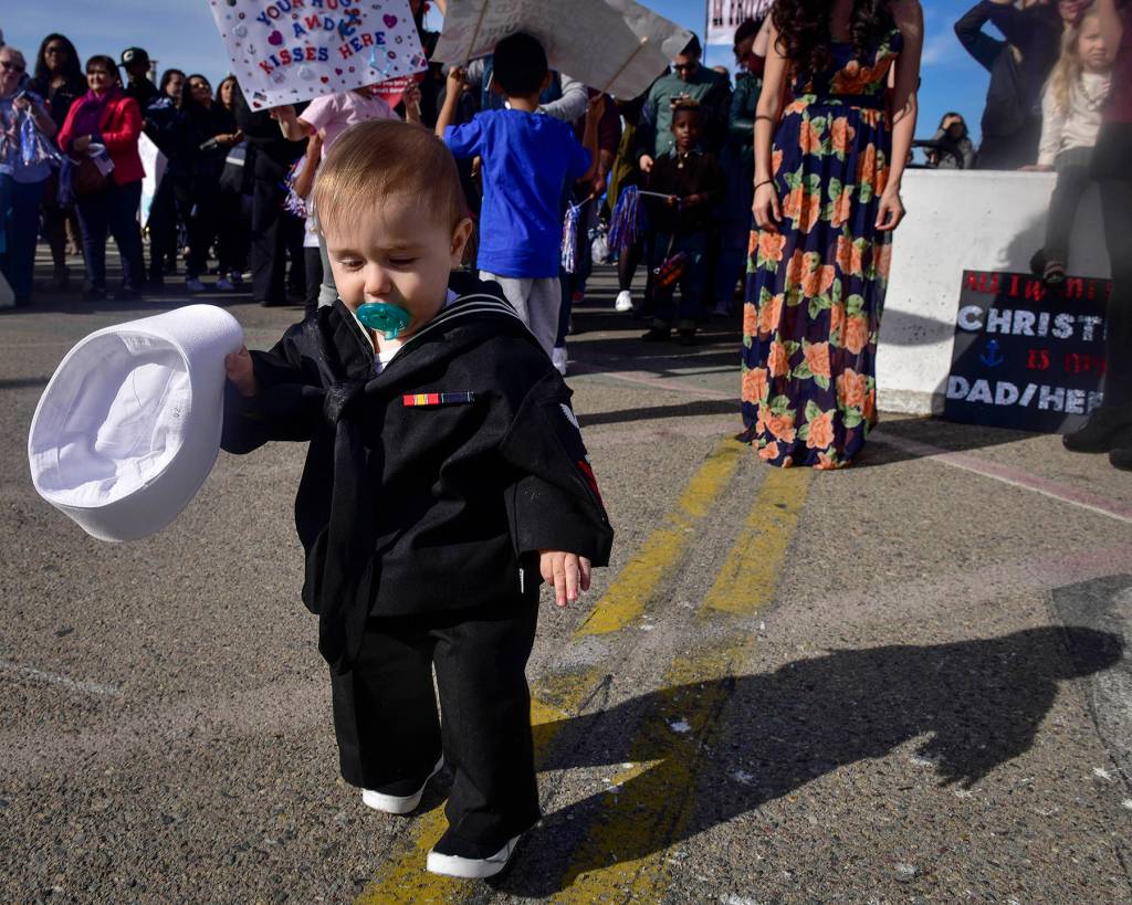 A U.S. Navy sailors son waits on the pier to meet his father for the first time after the aircraft carrier USS Nimitz (CVN 68) returned to Naval Air Station North Island, Dec. 5 in Coronado, California. The Nimitz Carrier Strike Group is on a regularly scheduled deployment to the Western Pacific. The U.S. Navy has patrolled the Indo-Asia-Pacific region routinely for more than 70 years promoting peace and security. (Mass Communication Specialist 3rd Class Emily Johnston/U.S. Navy)