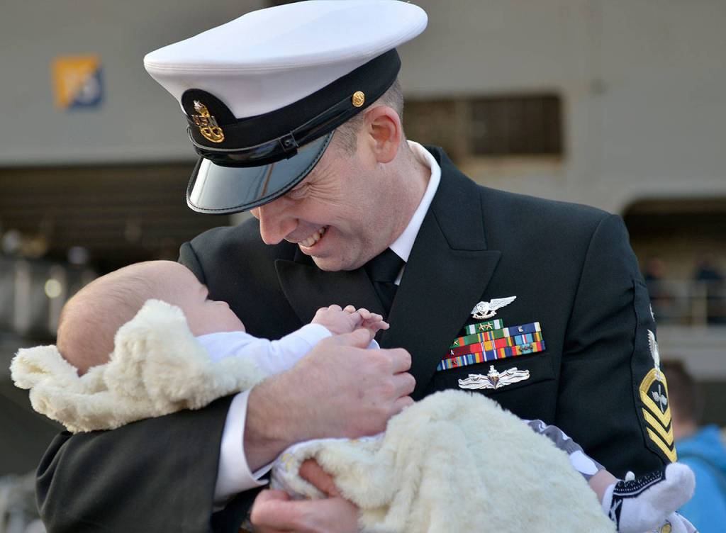 U.S. Navy Aviation Machinists Mate Senior Chief Jason Hewitt of Jacksonville, N.C., meets his son Kasen on the pier during the Nimitzs homecoming Dec. 10. (Photo: Mass Communication Specialist 3rd Class Ian Kinkead)