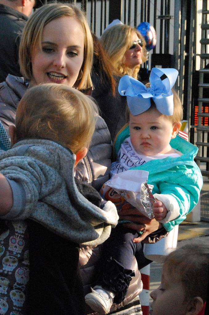 A Nimitz baby sports a big blue ribbon for her father, aboard the aircraft carrier. (Photo: Bob Smith | Kitsap News Group)