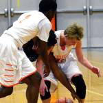 Central Kitsaps Zion Archer and Colby White battle Gig Harbors Malik Livingston for a loose ball in a Dec. 8 league contest. The Tides won 58-54. (Mark Krulish/Kitsap News Group)