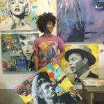 <em>Artist Cory Bennett with some of creative portraits he has done. Hes currently working on murals in Poulsbo. </em>Photo courtesy of Cory Bennett