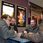 Friends, from left, Jesse Reynolds, Ryan French, Mike French and Ken Smith with Benjamin Komar (not pictured) play card games while waiting for the 3-D showing of Star Wars: Episode VII  The Force Awakens on opening night in 2015. Some of the sounds from the films come from animals in Sequim. (Matthew Nash /Olympic Peninsula News Group)