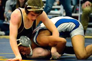 Mark Krulish | Kitsap News Group                                South Kitsap freshman Xavier Eaglin wrestles with Olympics Anjelo Pangelinan in the 106 finals at the HammerHead Invitational on Dec. 16.