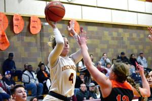 <em>Kingston senior Avy Hiner (4), lets go of a shot as shes surrounded by Central Kitsap defenders in her teams 59-49 victory on Dec. 20.</em>Mark Krulish/Kitsap News Group