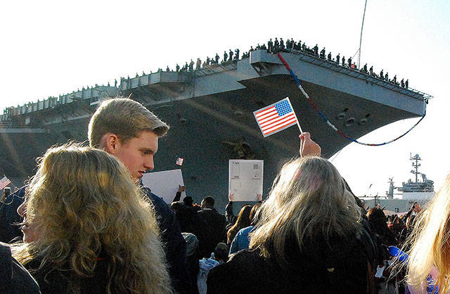 Families waited expectantly to see their loved ones shortly after the USS Nimitz returned to its home port of Bremerton in December. (Bob Smith | Kitsap Daily News)